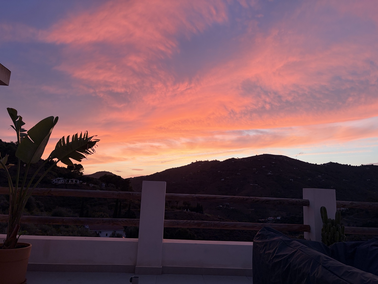 A pink sunset over the hills at Tierra Fina