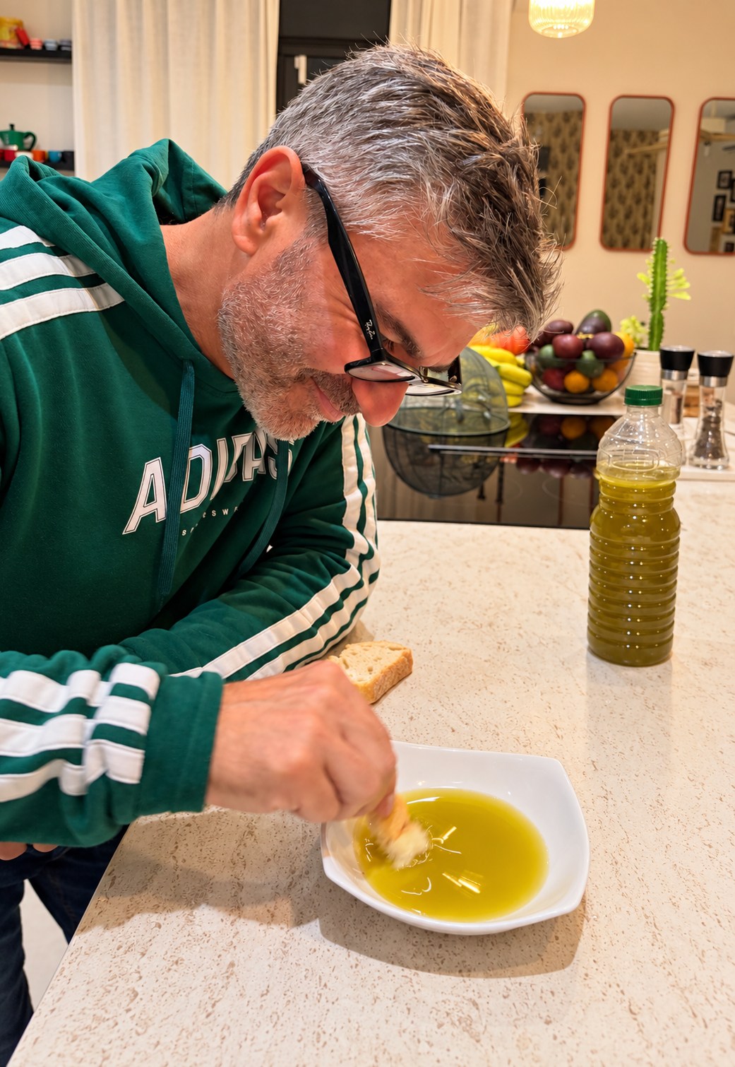 Sal tasting our fresh olive oil with bread at home